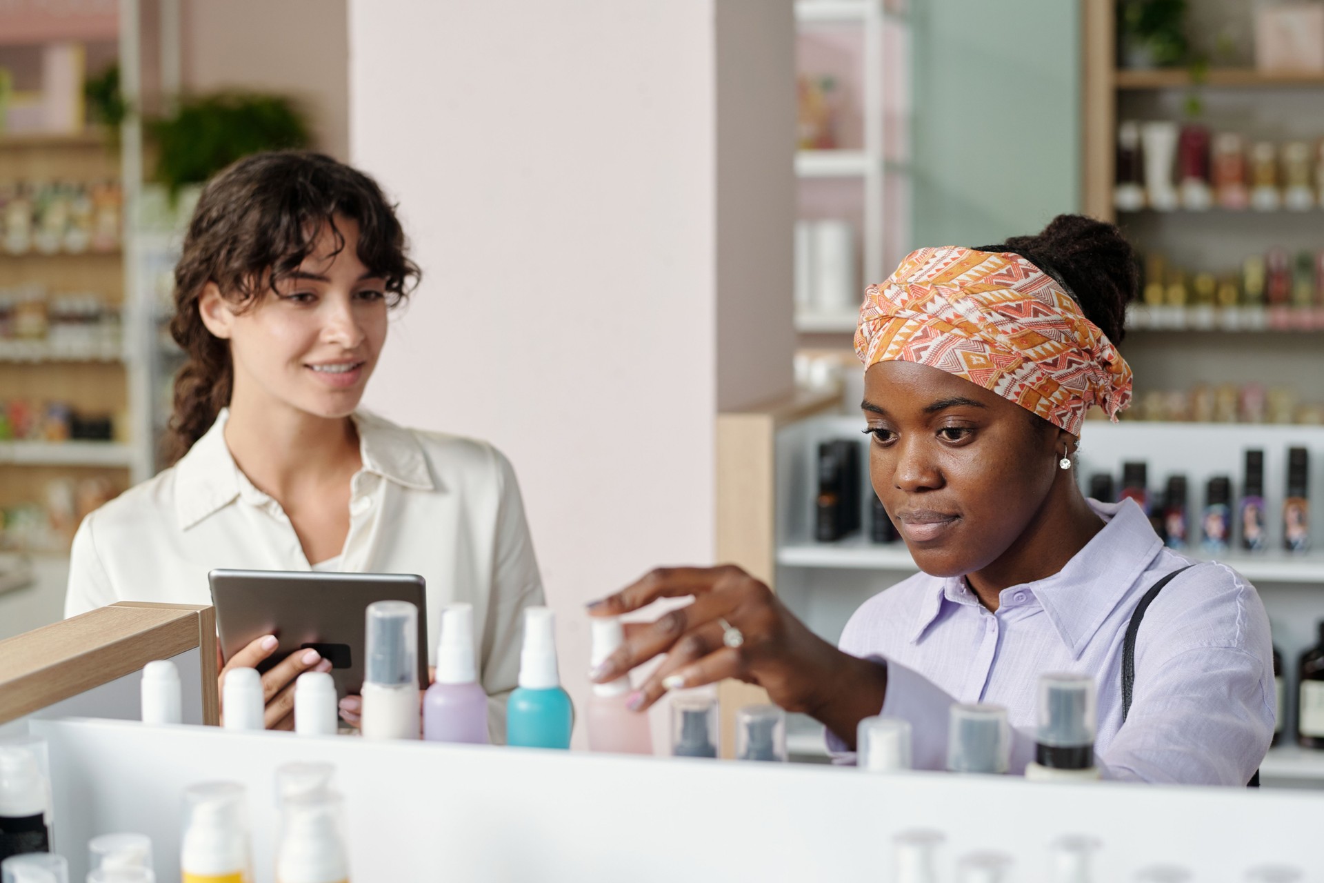 Young African American female consumer choosing beautycare product